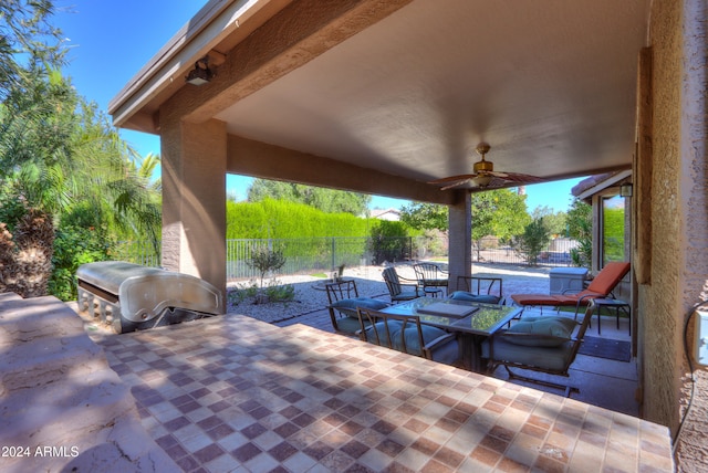 view of patio featuring area for grilling and ceiling fan