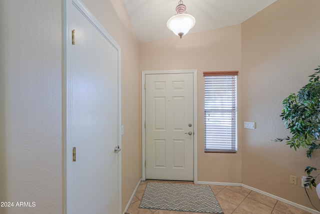 tiled foyer entrance with lofted ceiling