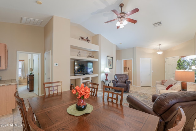 tiled dining area with vaulted ceiling, built in features, and ceiling fan