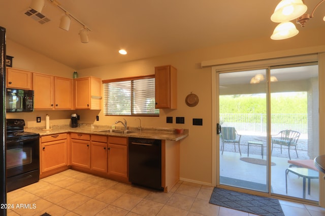 kitchen with a wealth of natural light, sink, black appliances, and lofted ceiling