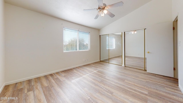 12445 N 21st Ave Unit 4, Phoenix, AZ 85029 - unfurnished bedroom with multiple closets, lofted ceiling, light wood finished floors, baseboards, and ceiling fan