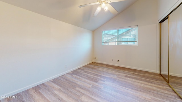 12445 N 21st Ave Unit 4, Phoenix, AZ 85029 - unfurnished bedroom with light wood-style flooring, baseboards, a closet, vaulted ceiling, and ceiling fan