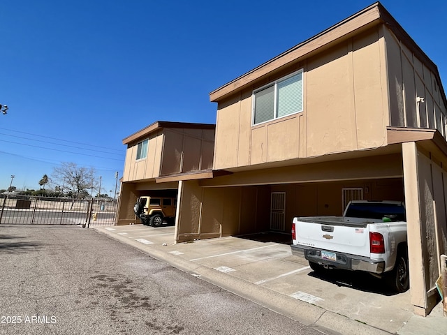 12445 N 21st Ave Unit 4, Phoenix, AZ 85029 - view of home's exterior with covered parking, a gate, and fence