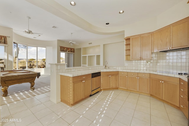 kitchen with light tile patterned floors, tile counters, dishwashing machine, pool table, and sink