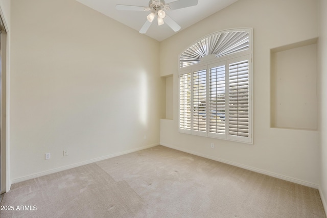 carpeted empty room with ceiling fan and lofted ceiling