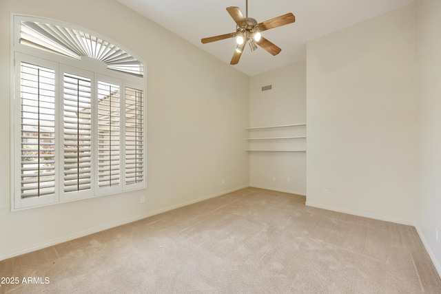 unfurnished room with ceiling fan and light colored carpet