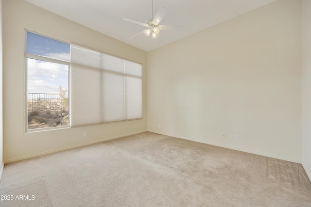 carpeted spare room with vaulted ceiling and ceiling fan