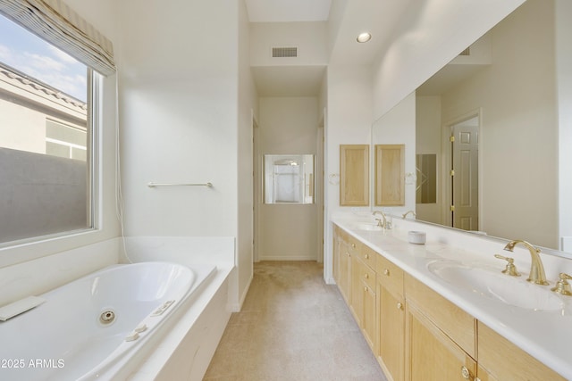 bathroom featuring vanity and a washtub