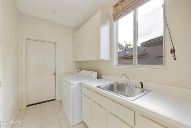 laundry room with independent washer and dryer, cabinets, sink, and light tile patterned floors