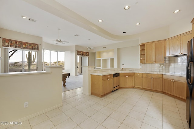 kitchen featuring sink, backsplash, light tile patterned flooring, stainless steel dishwasher, and kitchen peninsula