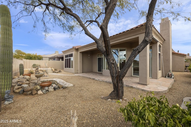 back of property with a patio