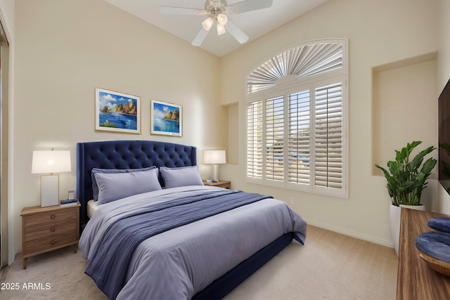 bedroom with ceiling fan, vaulted ceiling, and light carpet