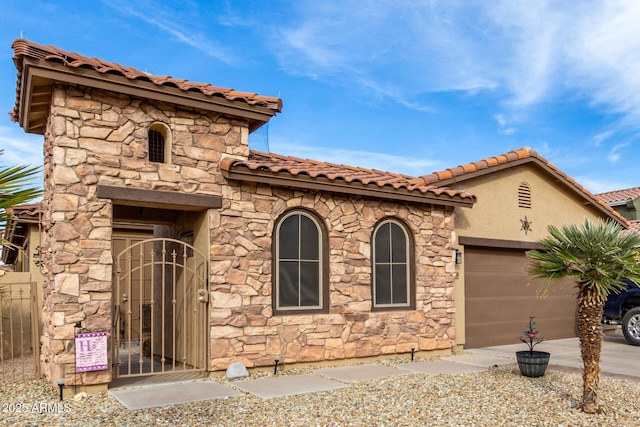 mediterranean / spanish-style home featuring a garage