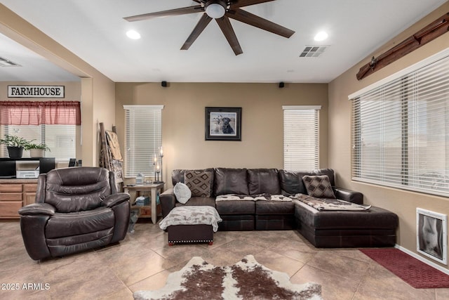 living room featuring light tile patterned floors and ceiling fan