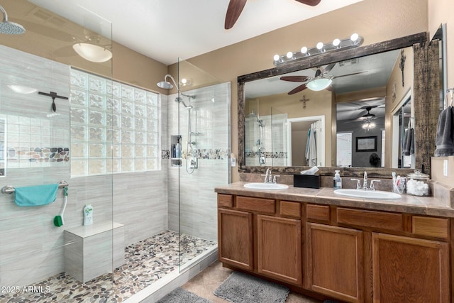 bathroom with tile patterned flooring, vanity, and walk in shower