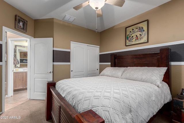 bedroom with carpet, ceiling fan, and a closet