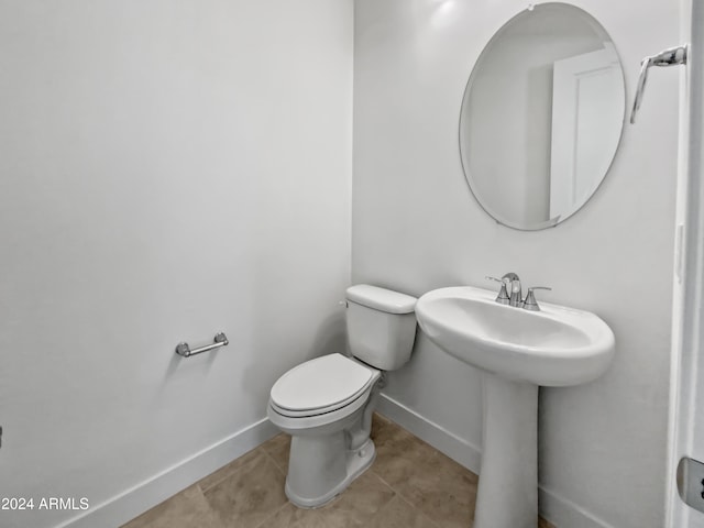 bathroom with tile patterned floors and toilet