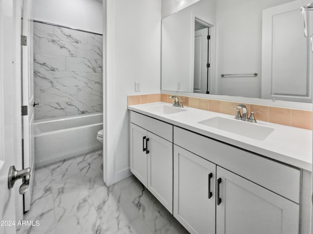 full bathroom featuring vanity, toilet, and tiled shower / bath