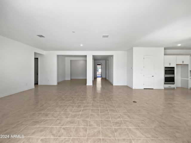 unfurnished living room featuring light tile patterned flooring