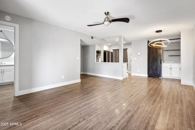 9340 N 92nd St Unit 118, Scottsdale, AZ 85258 - unfurnished living room featuring ceiling fan, baseboards, visible vents, and wood finished floors
