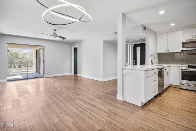 9340 N 92nd St Unit 118, Scottsdale, AZ 85258 - kitchen with a sink, visible vents, white cabinetry, light countertops, and appliances with stainless steel finishes