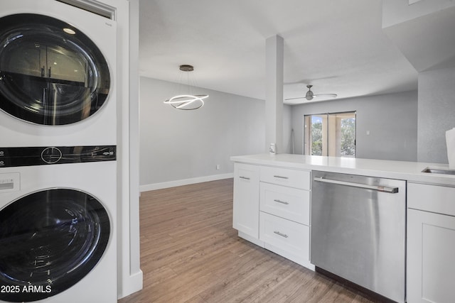 9340 N 92nd St Unit 118, Scottsdale, AZ 85258 - laundry area with baseboards, ceiling fan, light wood finished floors, and stacked washer and clothes dryer
