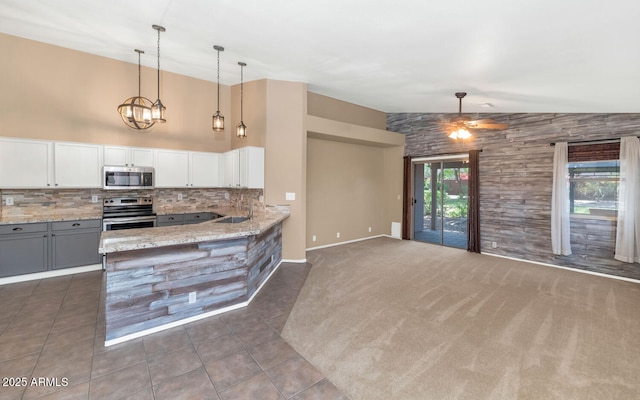 5733 E Jaeger St, Mesa, AZ 85205 - kitchen with appliances with stainless steel finishes, backsplash, lofted ceiling, ceiling fan, and light stone countertops