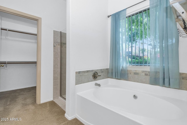 5733 E Jaeger St, Mesa, AZ 85205 - bathroom with a garden tub, a walk in closet, and a shower with shower door