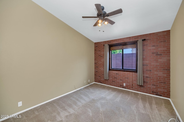 5733 E Jaeger St, Mesa, AZ 85205 - spare room featuring carpet floors, ceiling fan, and brick wall