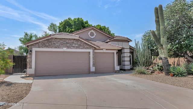 5733 E Jaeger St, Mesa, AZ 85205 - view of front of home with concrete driveway, stucco siding, an attached garage, and a tile roof