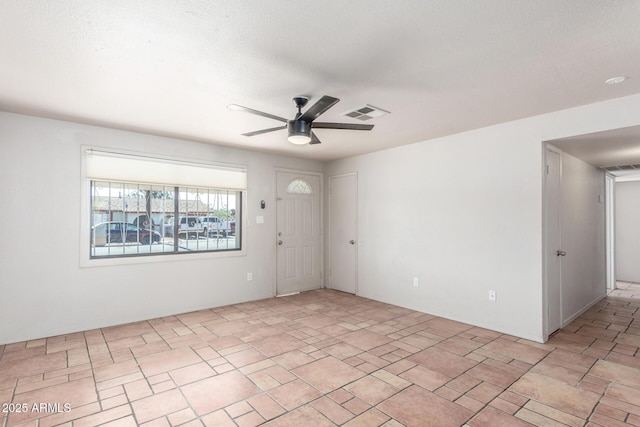 unfurnished room featuring a textured ceiling and ceiling fan