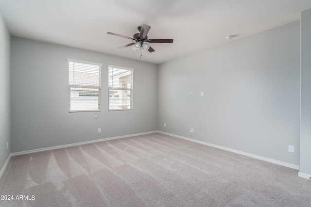 carpeted empty room featuring ceiling fan