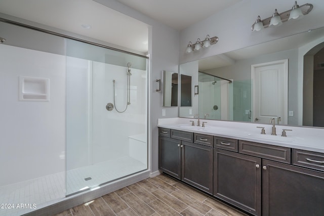 bathroom featuring vanity and a shower with shower door