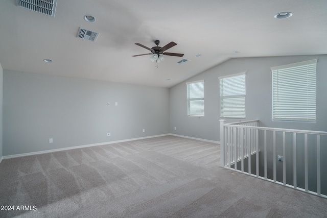 spare room with ceiling fan, light carpet, and lofted ceiling