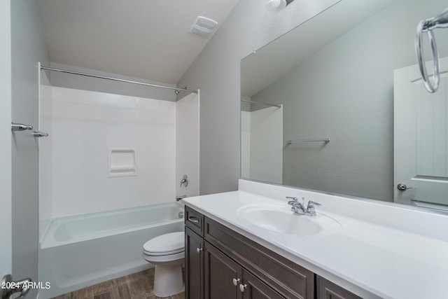 full bathroom with vanity, shower / bath combination, hardwood / wood-style flooring, and toilet