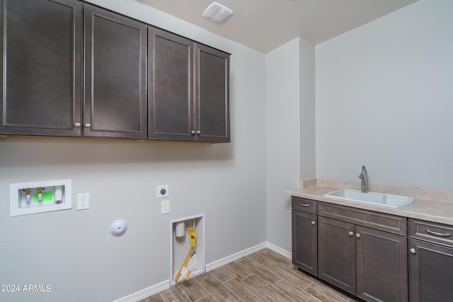 laundry room featuring sink, cabinets, electric dryer hookup, hookup for a gas dryer, and hookup for a washing machine