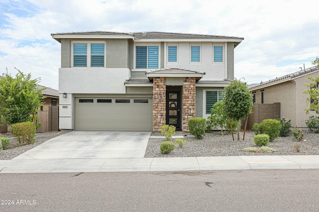 18813 W Solano Dr, Litchfield Park, AZ 85340 - view of front facade with stucco siding, a garage, driveway, and a tiled roof