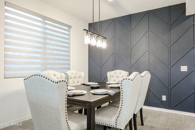 18813 W Solano Dr, Litchfield Park, AZ 85340 - dining area with baseboards, light wood-type flooring, and a decorative wall
