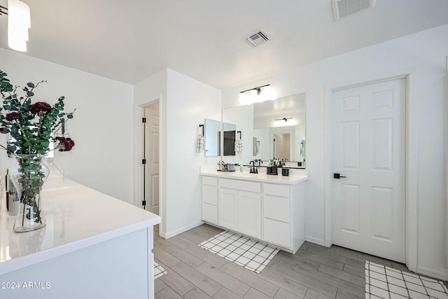 18813 W Solano Dr, Litchfield Park, AZ 85340 - full bathroom featuring vanity, wood finished floors, and baseboards
