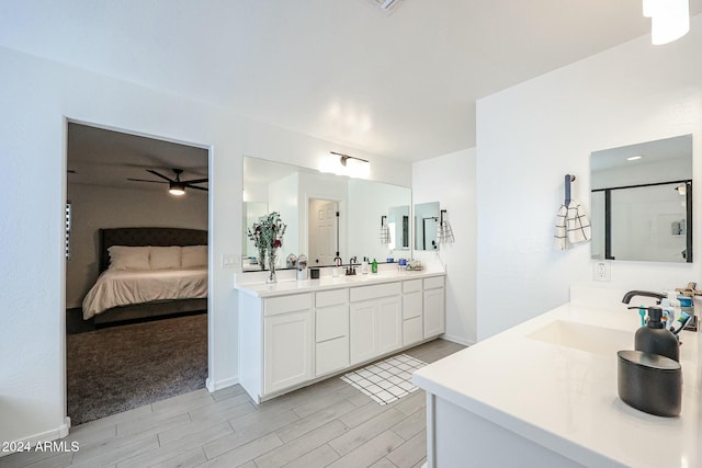 18813 W Solano Dr, Litchfield Park, AZ 85340 - ensuite bathroom with double vanity, a ceiling fan, and wood tiled floors