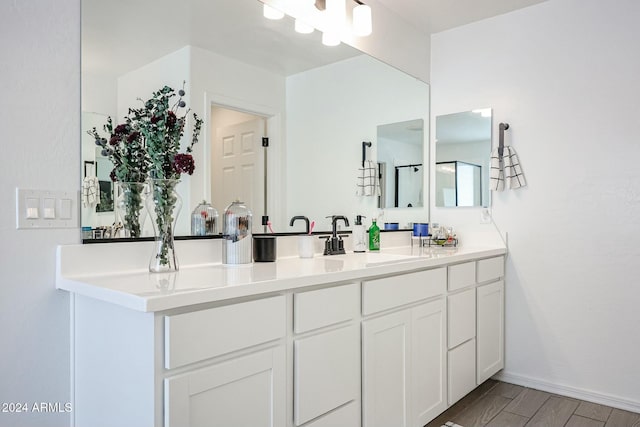 18813 W Solano Dr, Litchfield Park, AZ 85340 - bathroom featuring vanity, wood finished floors, and baseboards