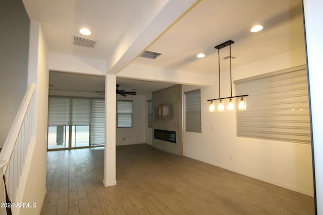 18813 W Solano Dr, Litchfield Park, AZ 85340 - unfurnished living room with ceiling fan, a large fireplace, wood finished floors, baseboards, and recessed lighting