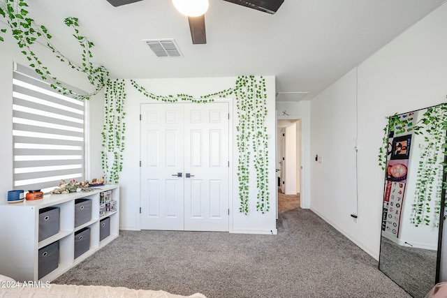 18813 W Solano Dr, Litchfield Park, AZ 85340 - unfurnished bedroom with carpet flooring, white refrigerator, a closet, ceiling fan, and baseboards