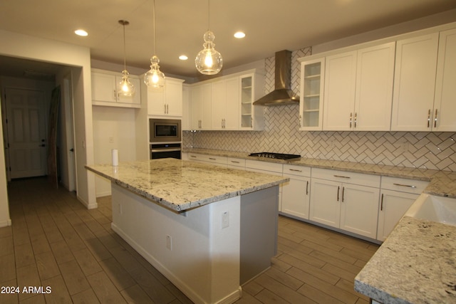 18813 W Solano Dr, Litchfield Park, AZ 85340 - kitchen featuring wall chimney range hood, stainless steel appliances, dark wood-style floors, decorative backsplash, and white cabinetry