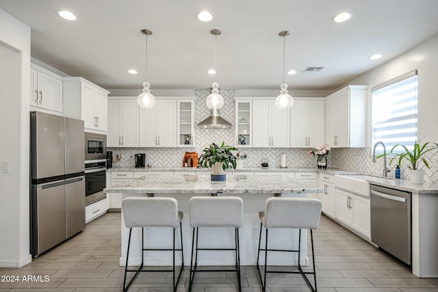 18813 W Solano Dr, Litchfield Park, AZ 85340 - kitchen featuring stainless steel appliances, tasteful backsplash, a center island, white cabinets, and recessed lighting