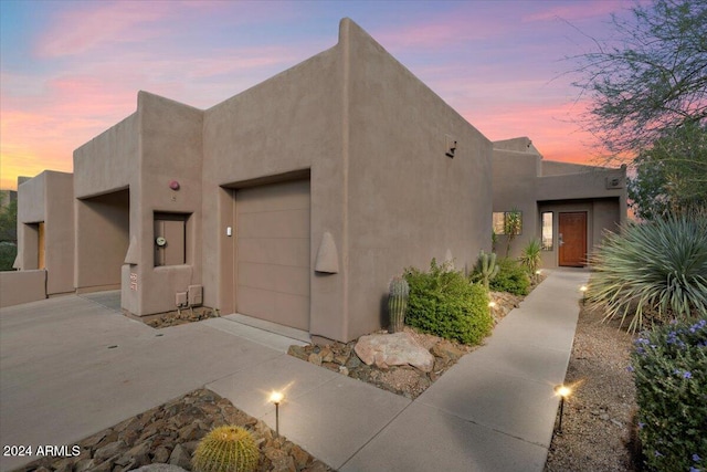 pueblo-style home with a garage