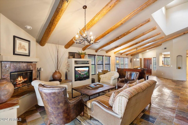 living room with vaulted ceiling with beams and a fireplace