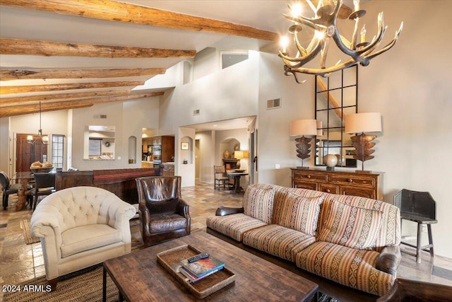 living room with an inviting chandelier and beam ceiling