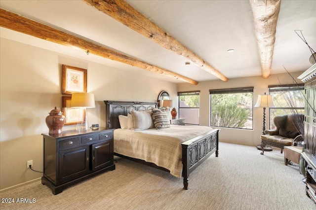 bedroom featuring beamed ceiling and light colored carpet