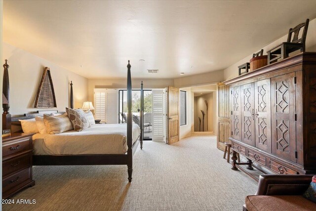 bedroom featuring light colored carpet